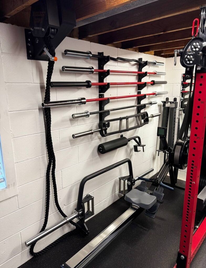 Barbell storage and rowing equipment inside a private personal training gym in Coon Rapids Minnesota